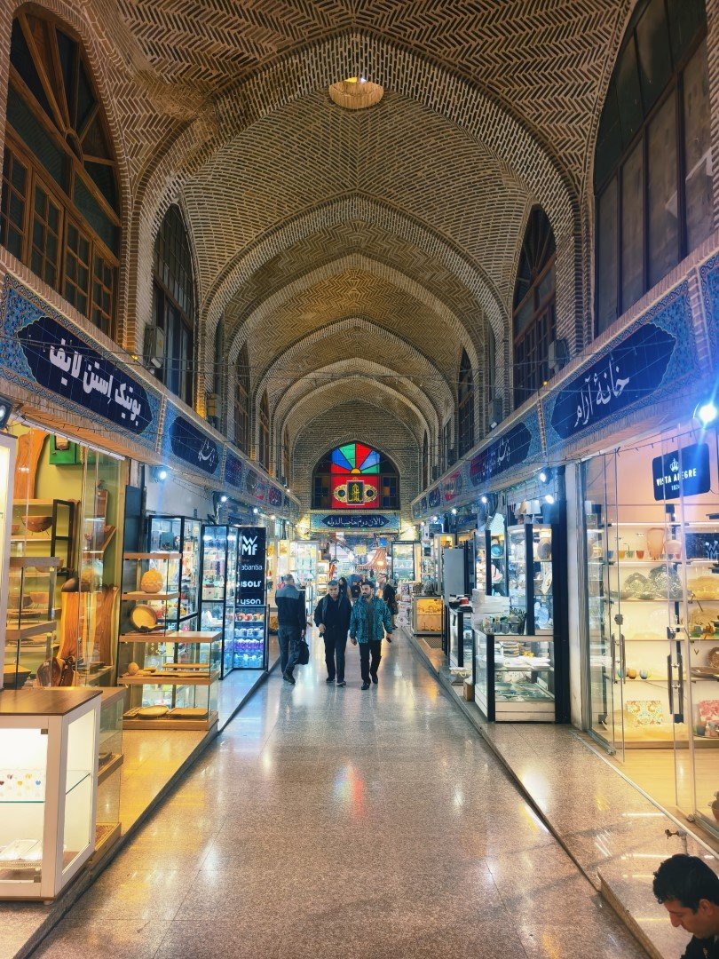 Grand Bazaar in Tehran — stalls and shoppers in a passage
